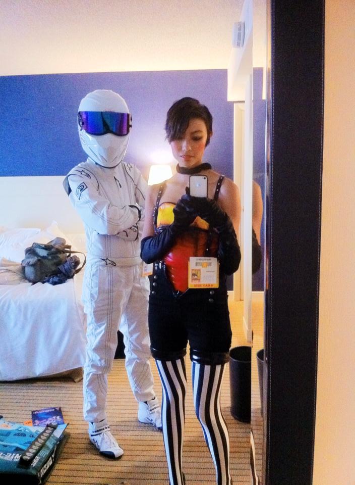 Andy and Michelle take a selfie in front of a mirror, at San Diego Comic Con 2014. Andy is cosplaying The Stig, a character from the show, Top Gear. Michelle is cosplaying as a character from a video game.