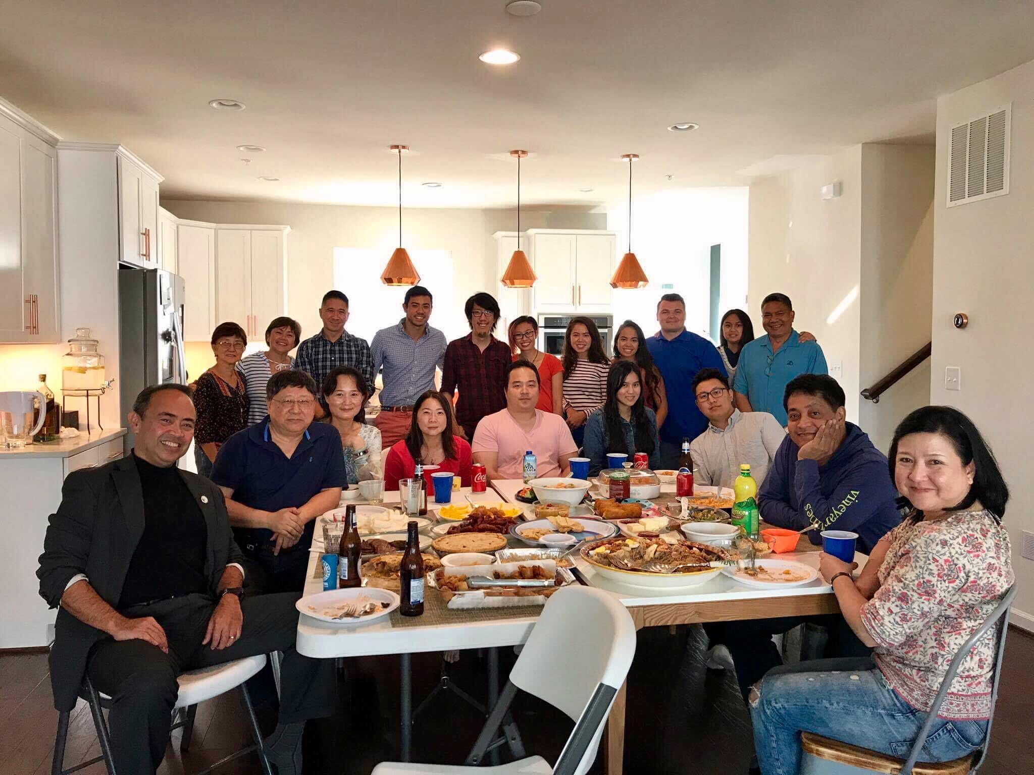 Photo of Andy and Michelle's families at Andy and Michelle's new kitchen. From left to right, bottom row: Jovey, Han, Tina, Isabelle, Ken, Wendy, Mike, Bob, Florence. Top row: Florence's Mom, Joann, Mitchie, Matthan, Andy, Michelle, Janis, Ricky, Ray, Mariel, Ben Senior.